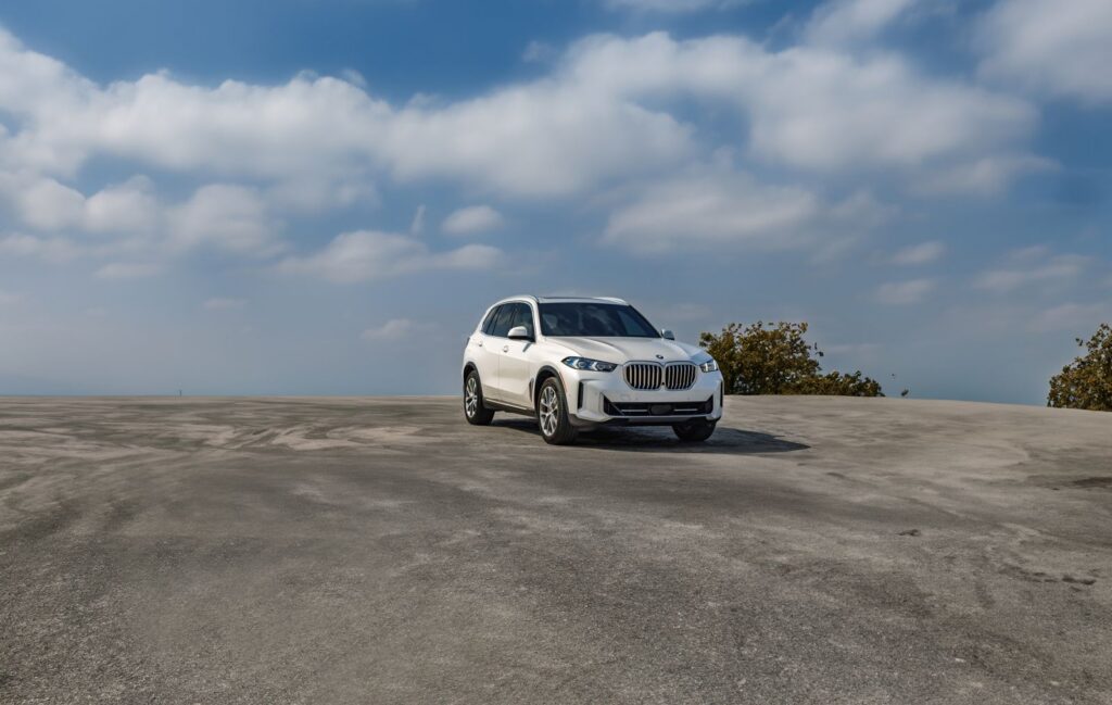 BMW X5 parked outdoors beneath a blue sky