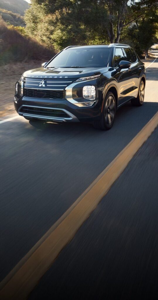 Black Mitsubishi Outlander SUV driving outdoors